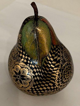 A wooden pear with intricately painted patterns.